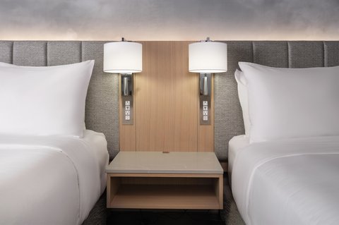 Two queen beds with a shared nightstand for added ease.