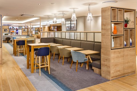 Relaxed bar and lounge seating with modern tables and booths
