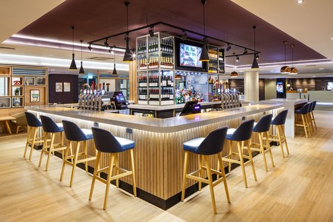 Stylish lobby bar with seating, lighting and central bar feature