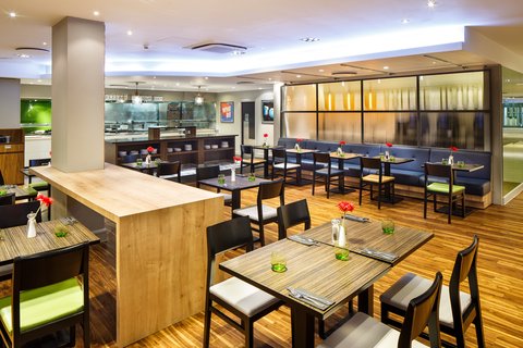 Modern restaurant with booth seating and warm ambient lighting