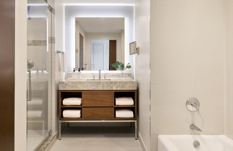 Spa-style bathroom with double vanity and glass walk-in shower.