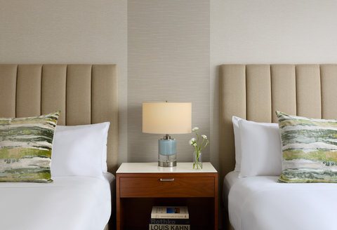 Bed with upholstered headboard and bedside lamp.