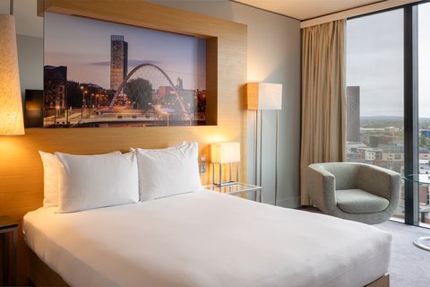 Relax in a bright Queen Classic room with sweeping skyline vistas
